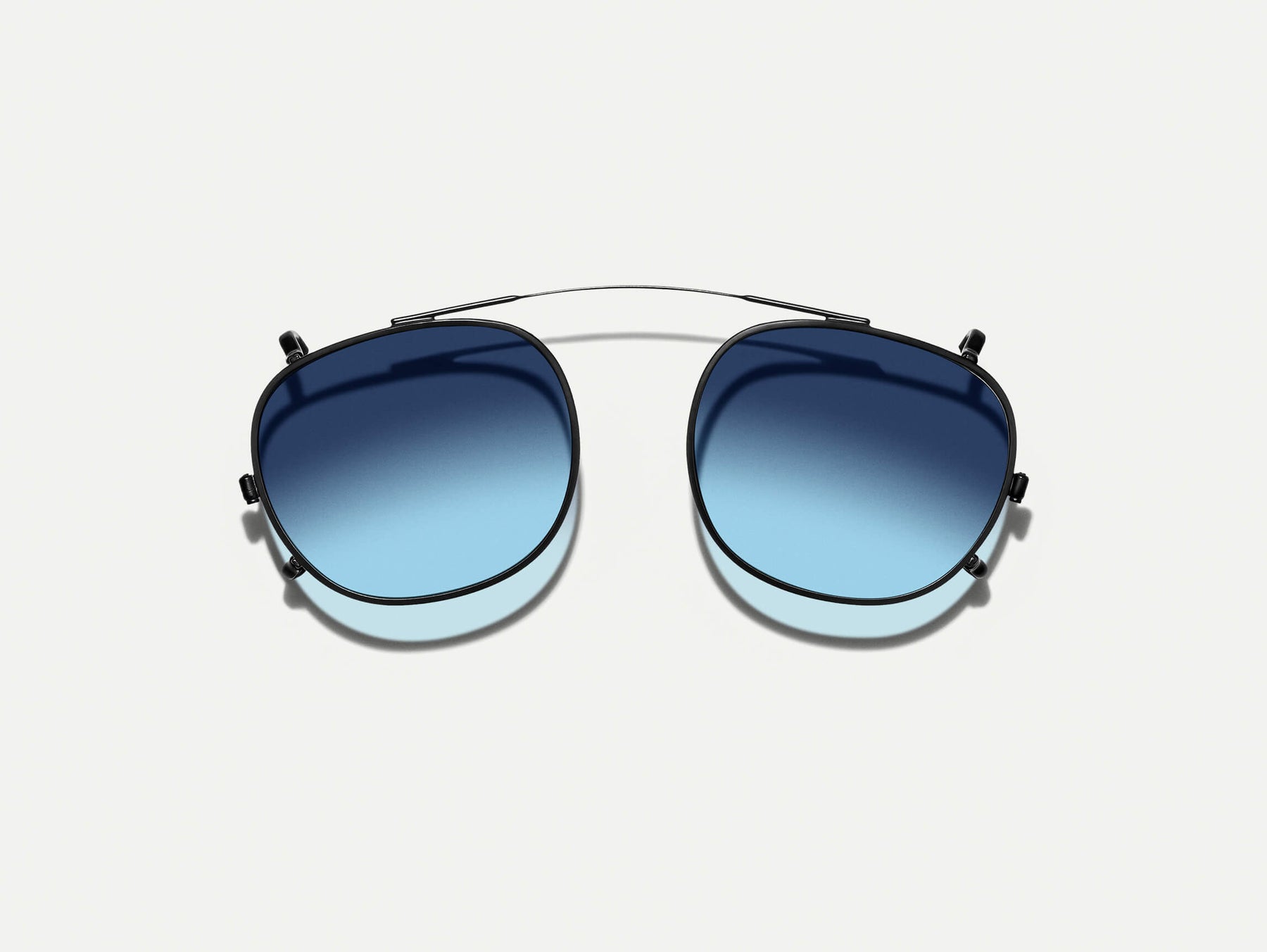 The CLIPTOSH in Matte Black with Denim Blue Tinted Lenses The CLIPTOSH in Matte Black with Denim Blue Tinted Lenses