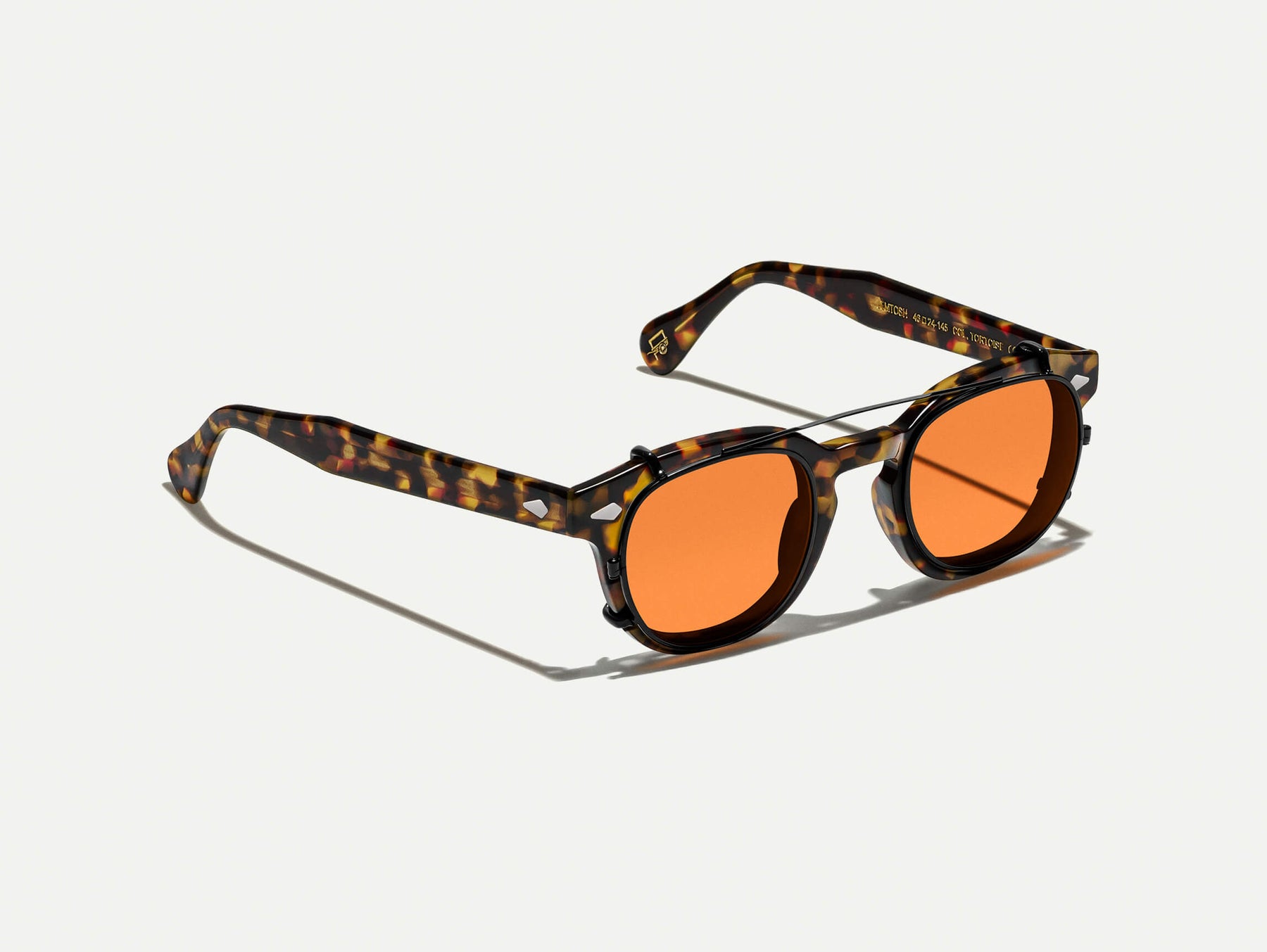 The CLIPTOSH in Matte Black with Woodstock Orange Tinted Lenses The CLIPTOSH in Matte Black with Woodstock Orange Tinted Lenses