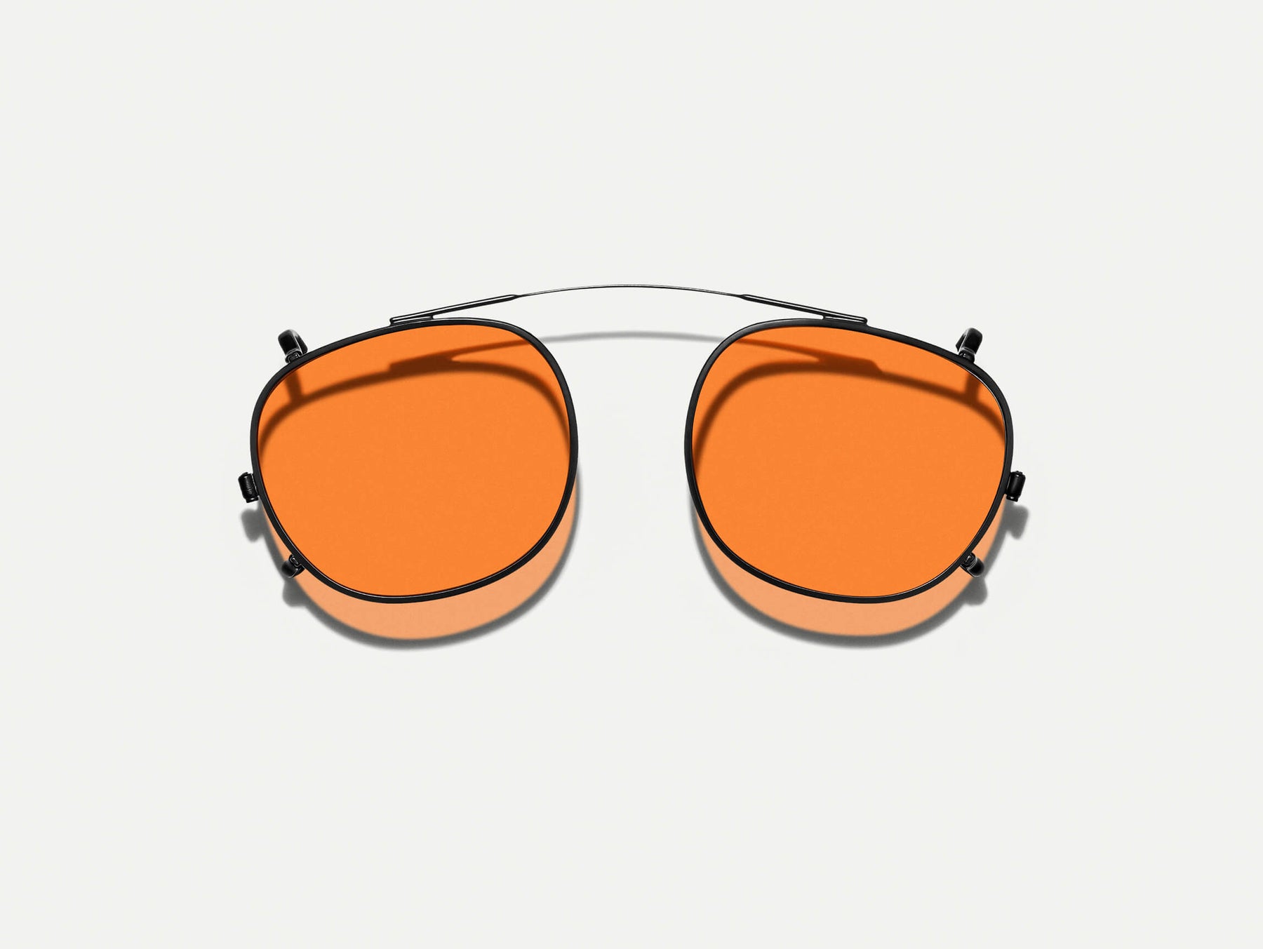 The CLIPTOSH in Matte Black with Woodstock Orange Tinted Lenses The CLIPTOSH in Matte Black with Woodstock Orange Tinted Lenses