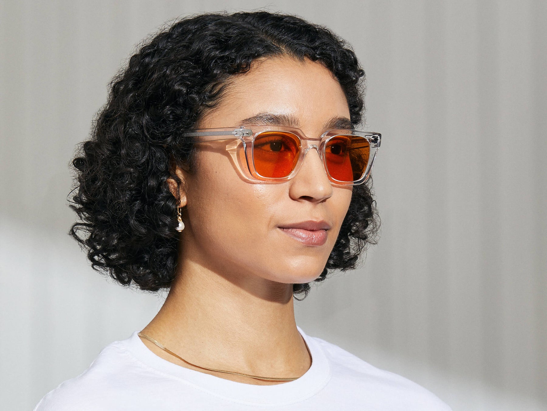 Model is wearing The GROBER in Crystal in size 48 with Woodstock Orange Tinted Lenses Model is wearing The GROBER in Crystal in size 48 with Woodstock Orange Tinted Lenses