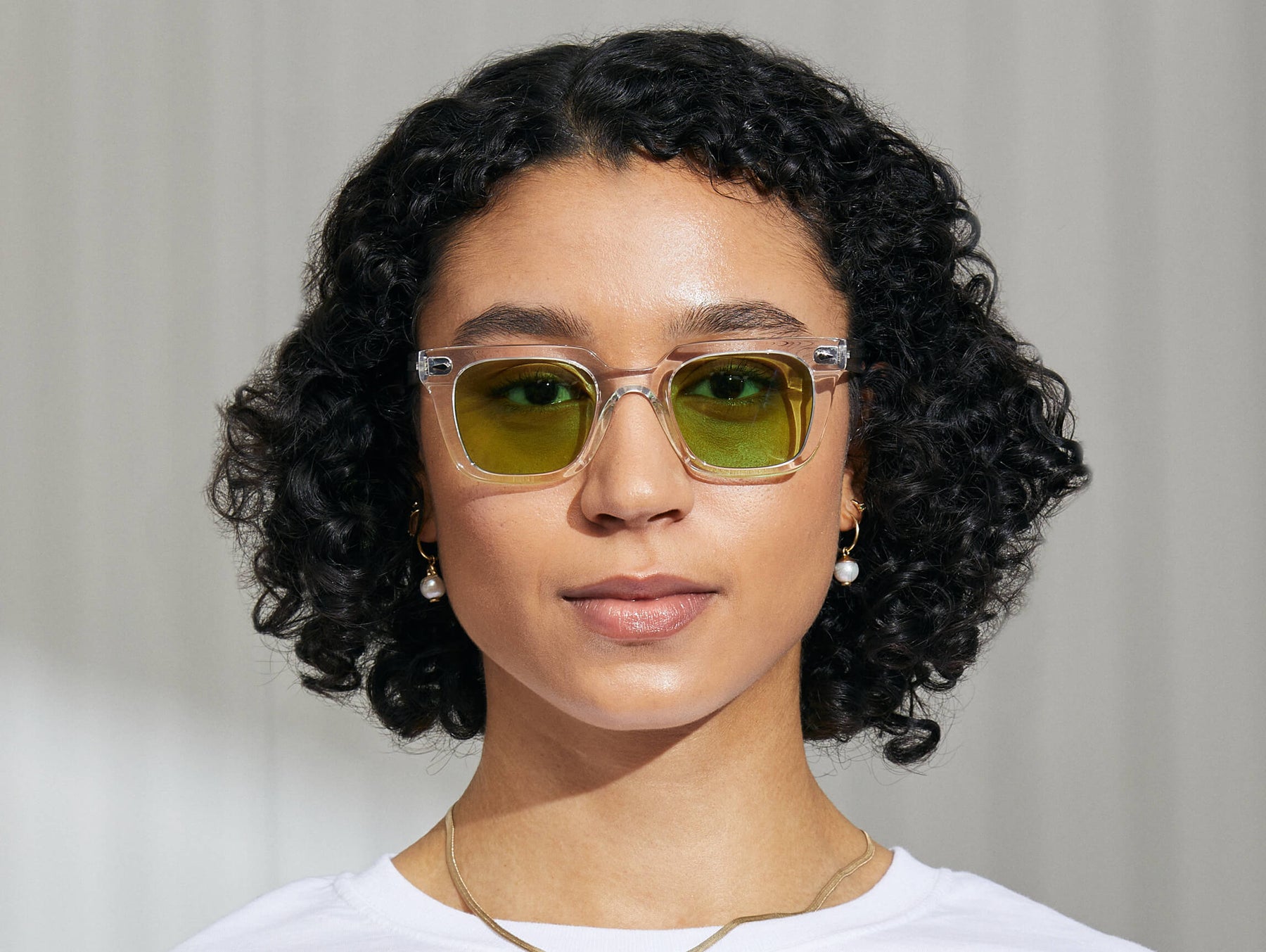 Model is wearing The GROBER in Crystal in size 48 with Garnet Green Tinted Lenses Model is wearing The GROBER in Crystal in size 48 with Garnet Green Tinted Lenses