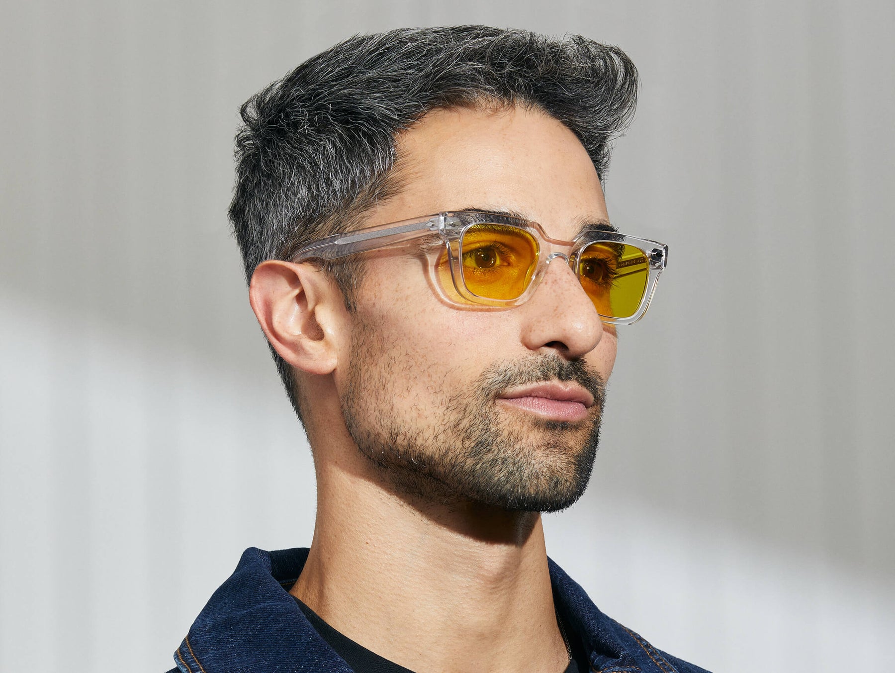 Model is wearing The GROBER in Crystal in size 45 with Mellow Yellow Tinted Lenses Model is wearing The GROBER in Crystal in size 45 with Mellow Yellow Tinted Lenses