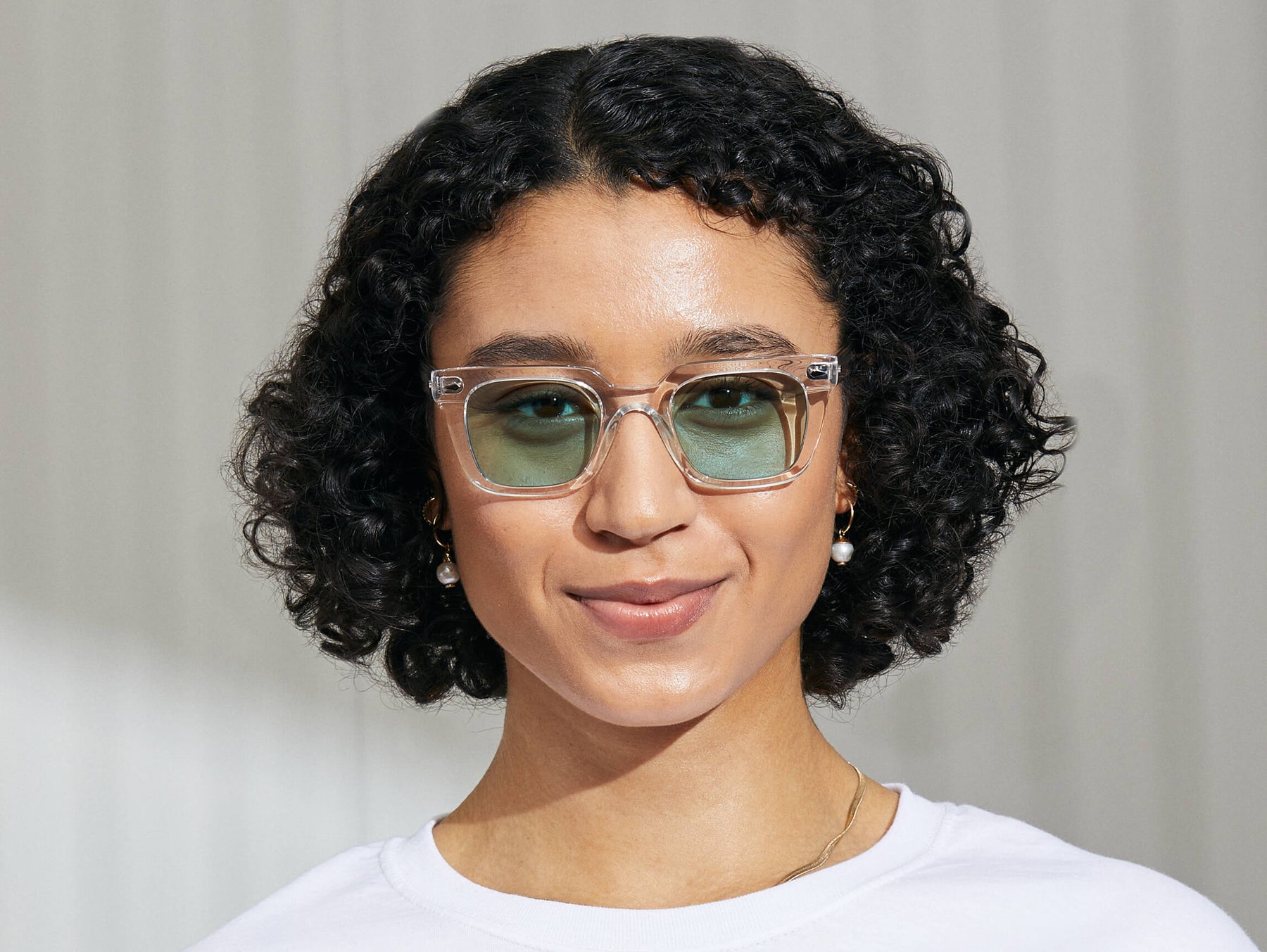Model is wearing The GROBER in Crystal in size 48 with Turquoise Tinted Lenses Model is wearing The GROBER in Crystal in size 48 with Turquoise Tinted Lenses