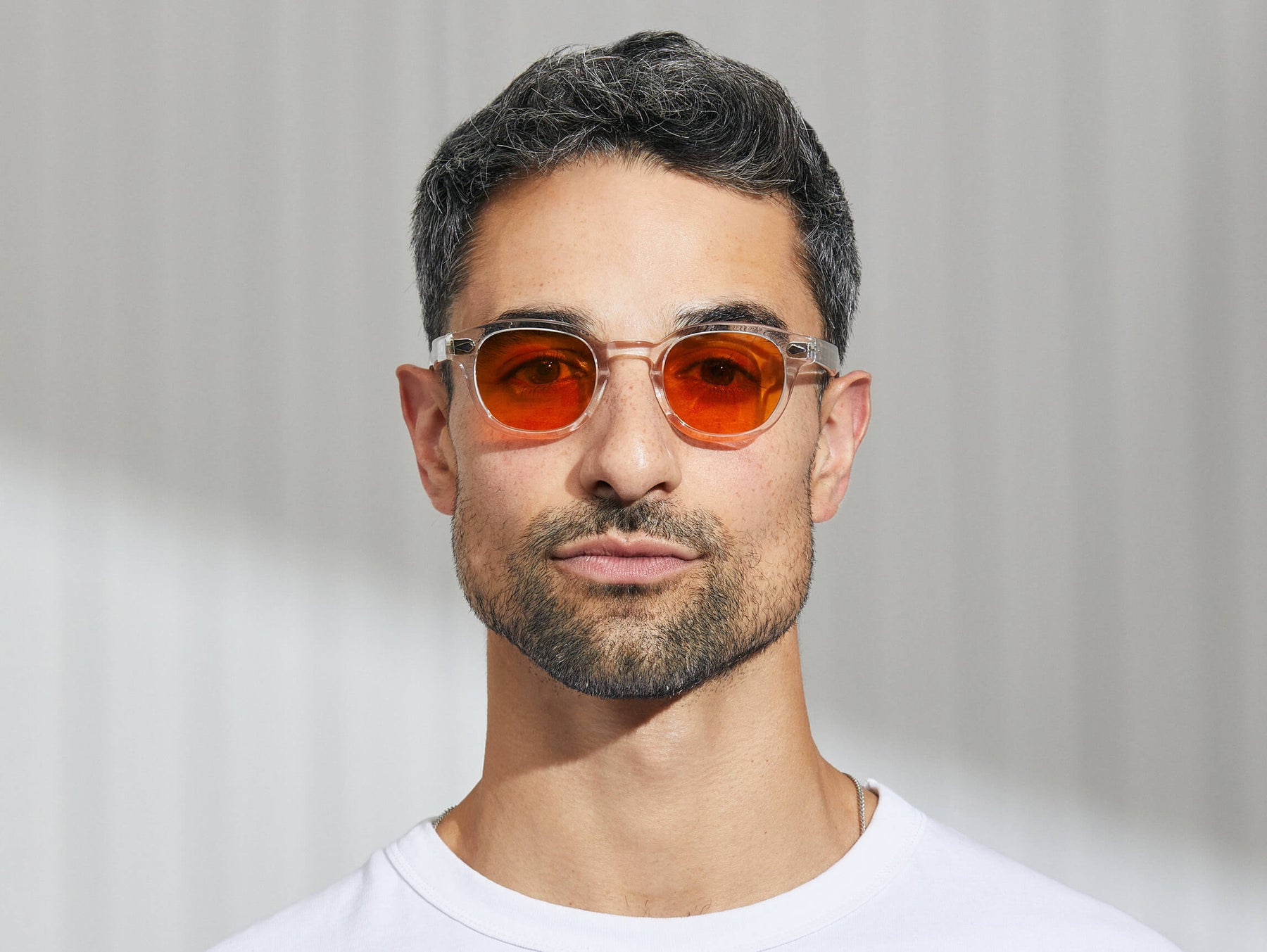 Model is wearing The LEMTOSH in Crystal in size 46 with Woodstock Orange Tinted Lenses Model is wearing The LEMTOSH in Crystal in size 46 with Woodstock Orange Tinted Lenses