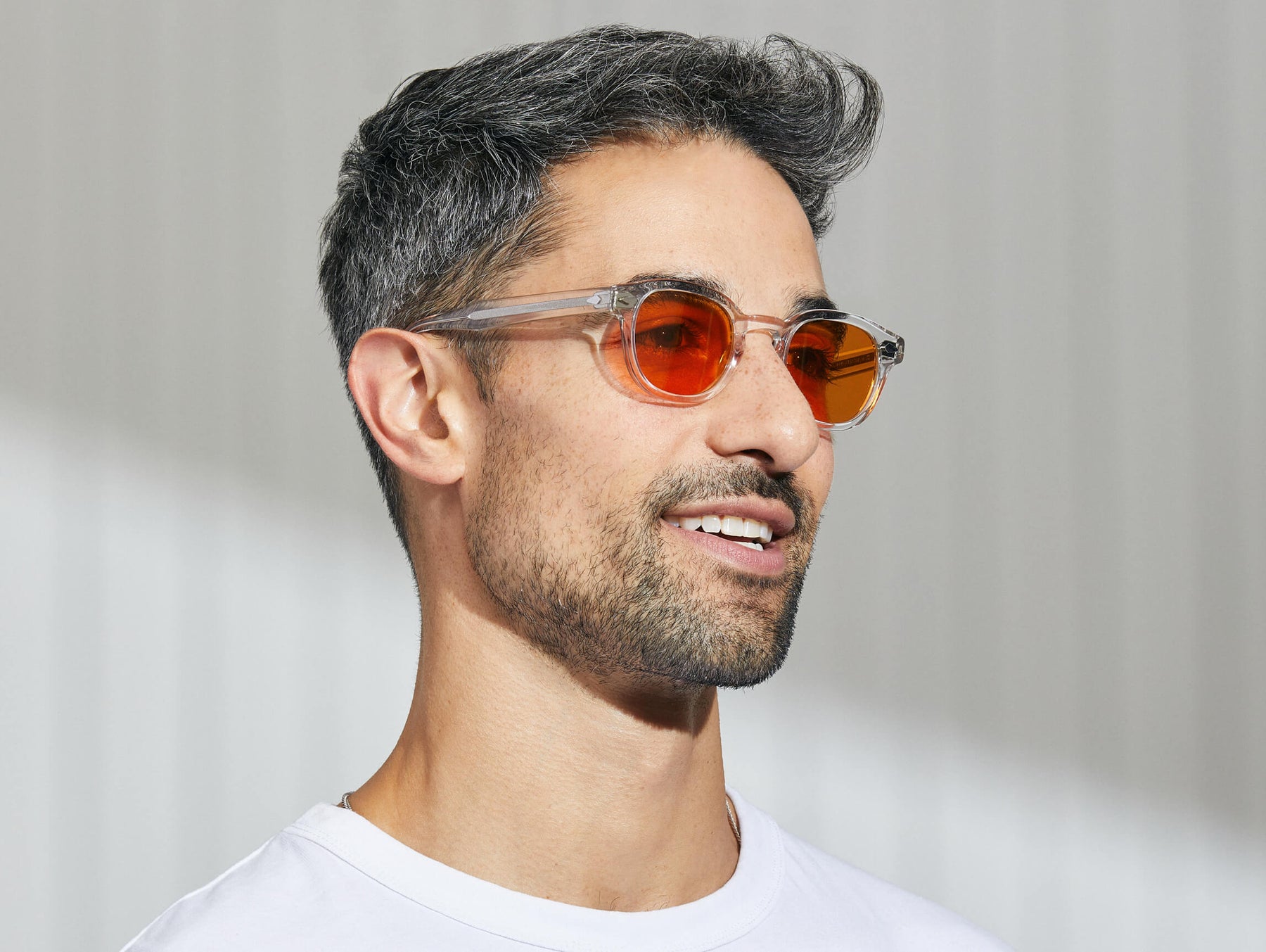 Model is wearing The LEMTOSH in Crystal in size 46 with Woodstock Orange Tinted Lenses Model is wearing The LEMTOSH in Crystal in size 46 with Woodstock Orange Tinted Lenses