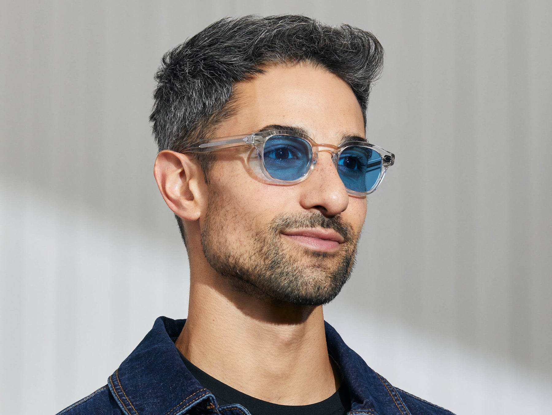 Model is wearing The LEMTOSH in Crystal in size 46 with Celebrity Blue Tinted Lenses Model is wearing The LEMTOSH in Crystal in size 46 with Celebrity Blue Tinted Lenses