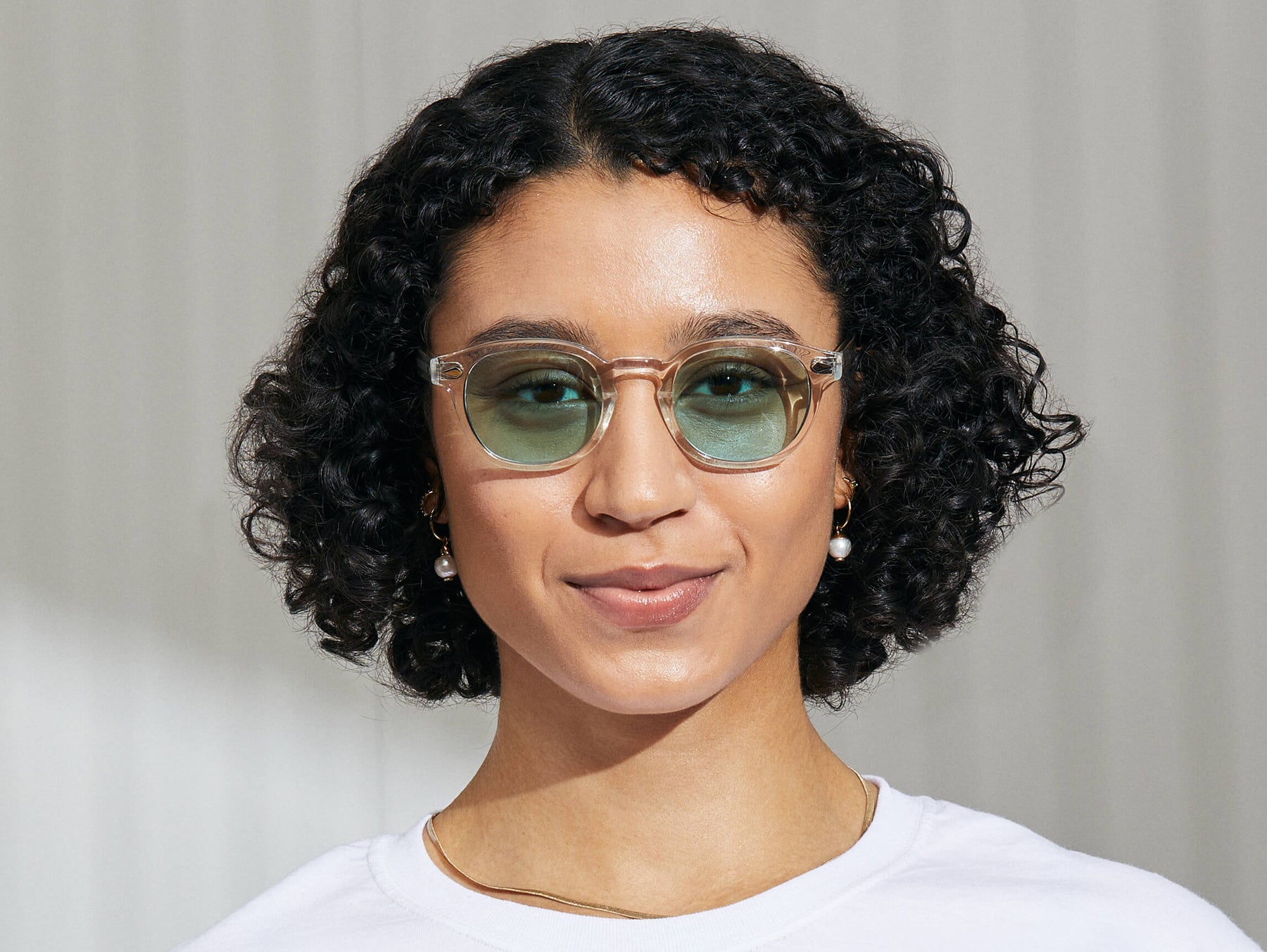 Model is wearing The LEMTOSH in Crystal in size 49 with Turquoise Tinted Lenses Model is wearing The LEMTOSH in Crystal in size 49 with Turquoise Tinted Lenses
