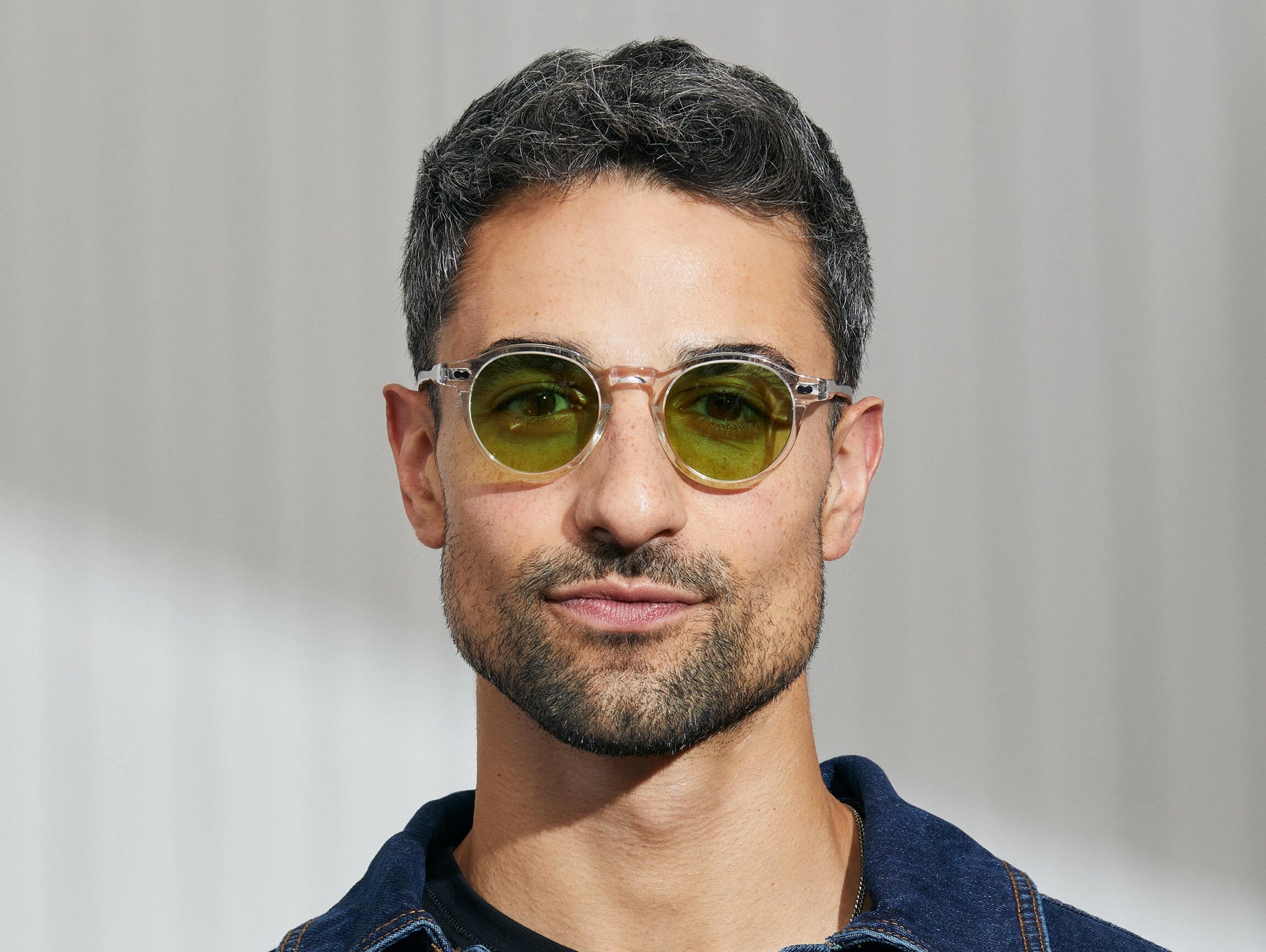 Model is wearing The MILTZEN in Crystal in size 46 with Garnet Green Tinted Lenses Model is wearing The MILTZEN in Crystal in size 46 with Garnet Green Tinted Lenses