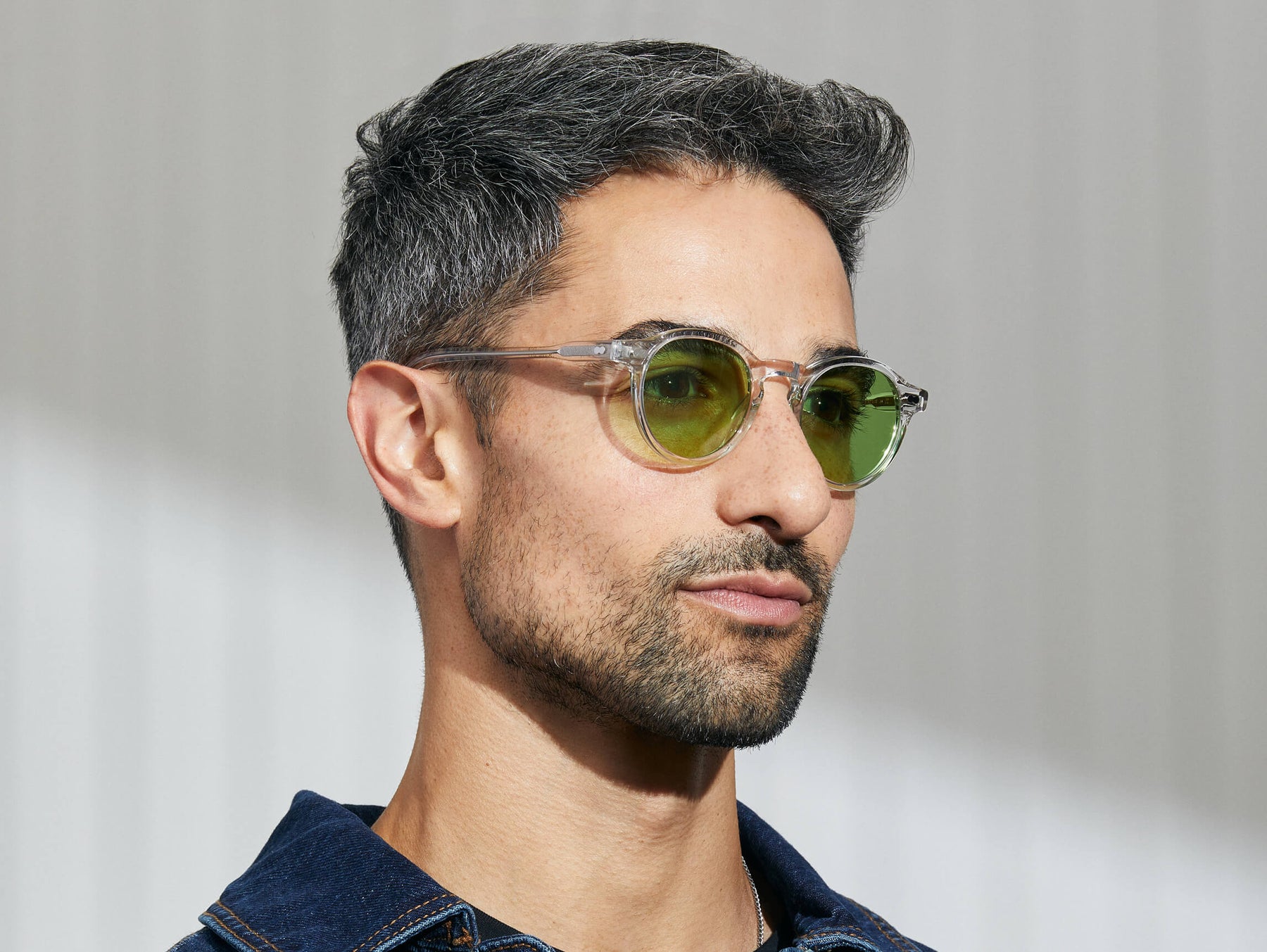 Model is wearing The MILTZEN in Crystal in size 46 with Garnet Green Tinted Lenses Model is wearing The MILTZEN in Crystal in size 46 with Garnet Green Tinted Lenses
