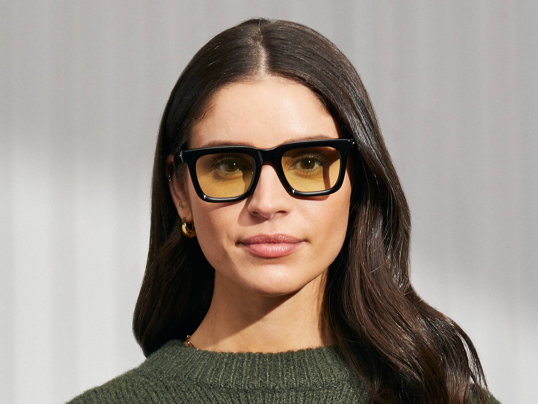 Model is wearing The RIZIK in Black in size 49 with Limelight Tinted Lenses Model is wearing The RIZIK in Black in size 49 with Limelight Tinted Lenses