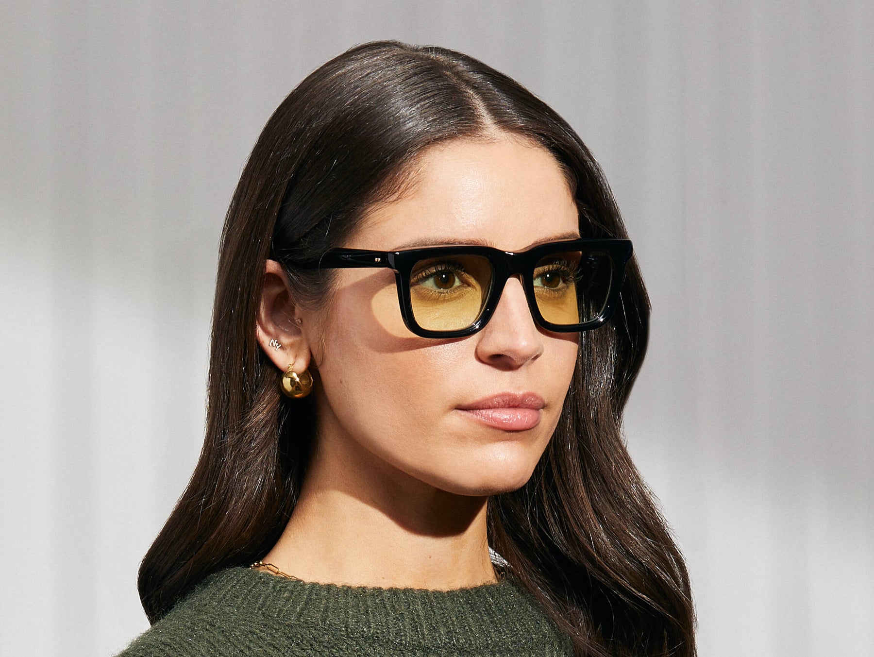 Model is wearing The RIZIK in Black in size 49 with Limelight Tinted Lenses Model is wearing The RIZIK in Black in size 49 with Limelight Tinted Lenses