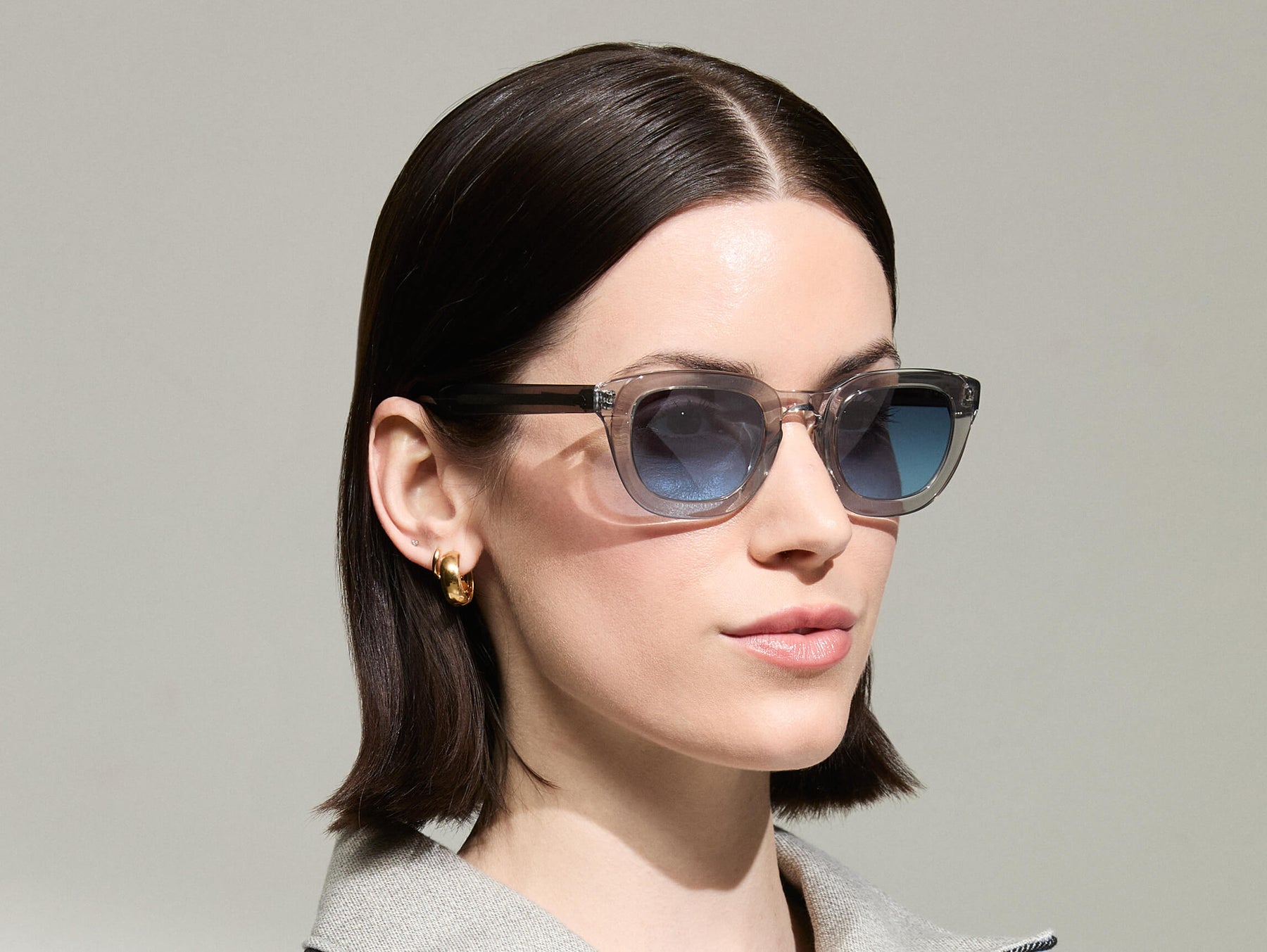 Model is wearing The TELENA in Grey/Light Grey in size 47 with Denim Blue Tinted Lenses Model is wearing The TELENA in Grey/Light Grey in size 47 with Denim Blue Tinted Lenses