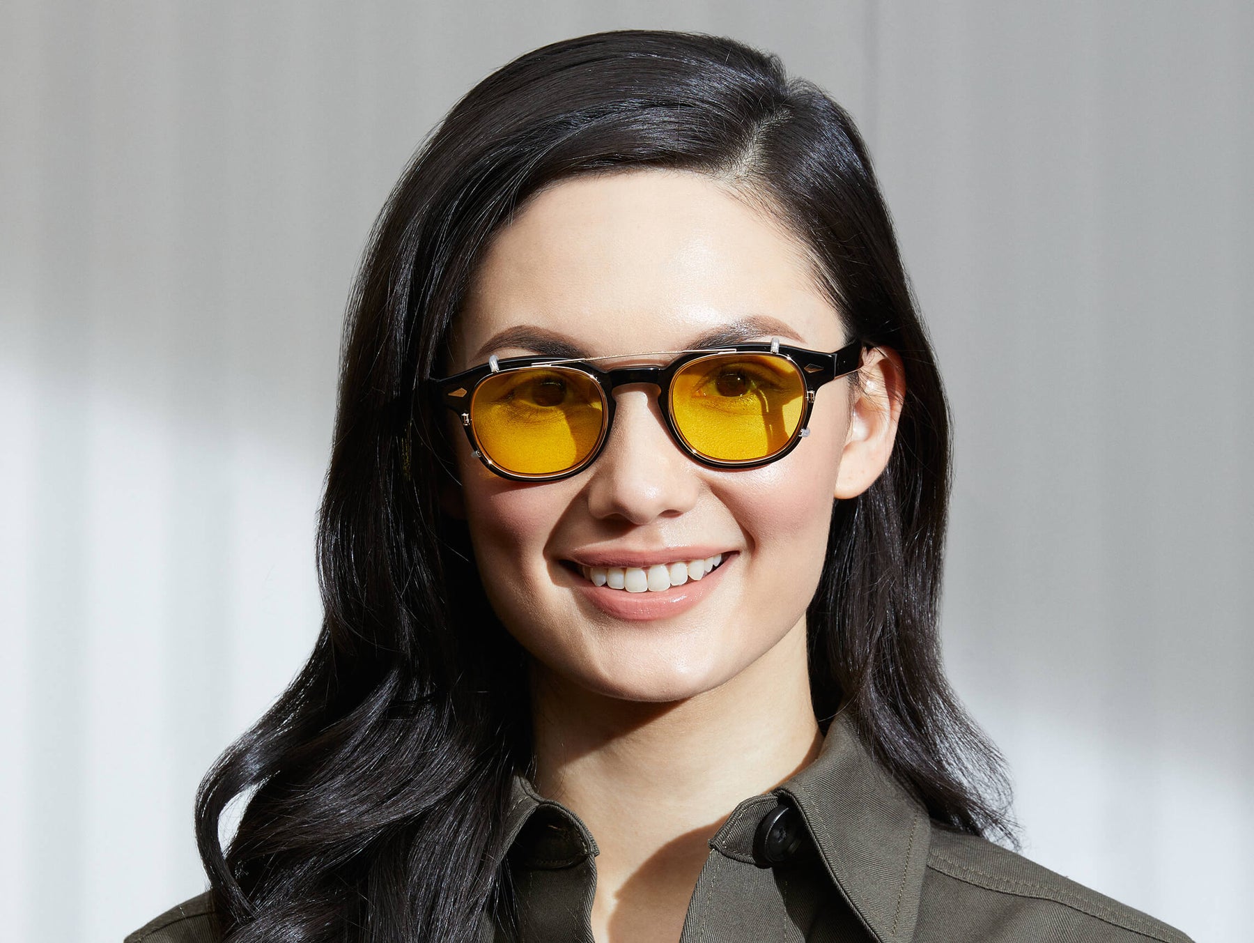 Model is wearing The CLIPTOSH in Gold in size 46 with Mellow Yellow Tinted Lenses Model is wearing The CLIPTOSH in Gold in size 46 with Mellow Yellow Tinted Lenses