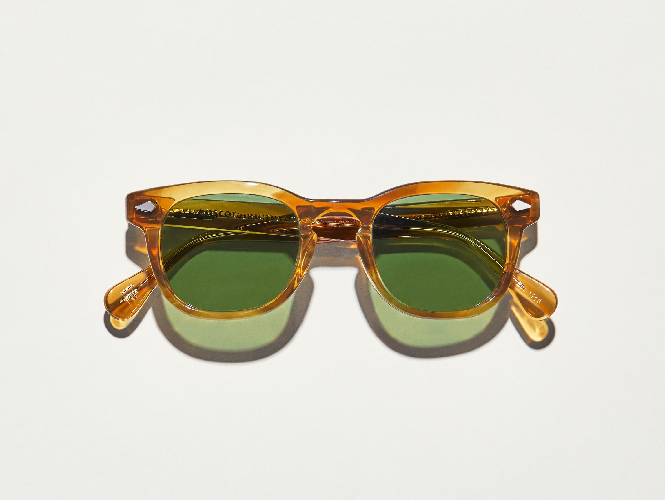 The GELT SUN in Honey Blonde with Calibar Green Glass Lenses