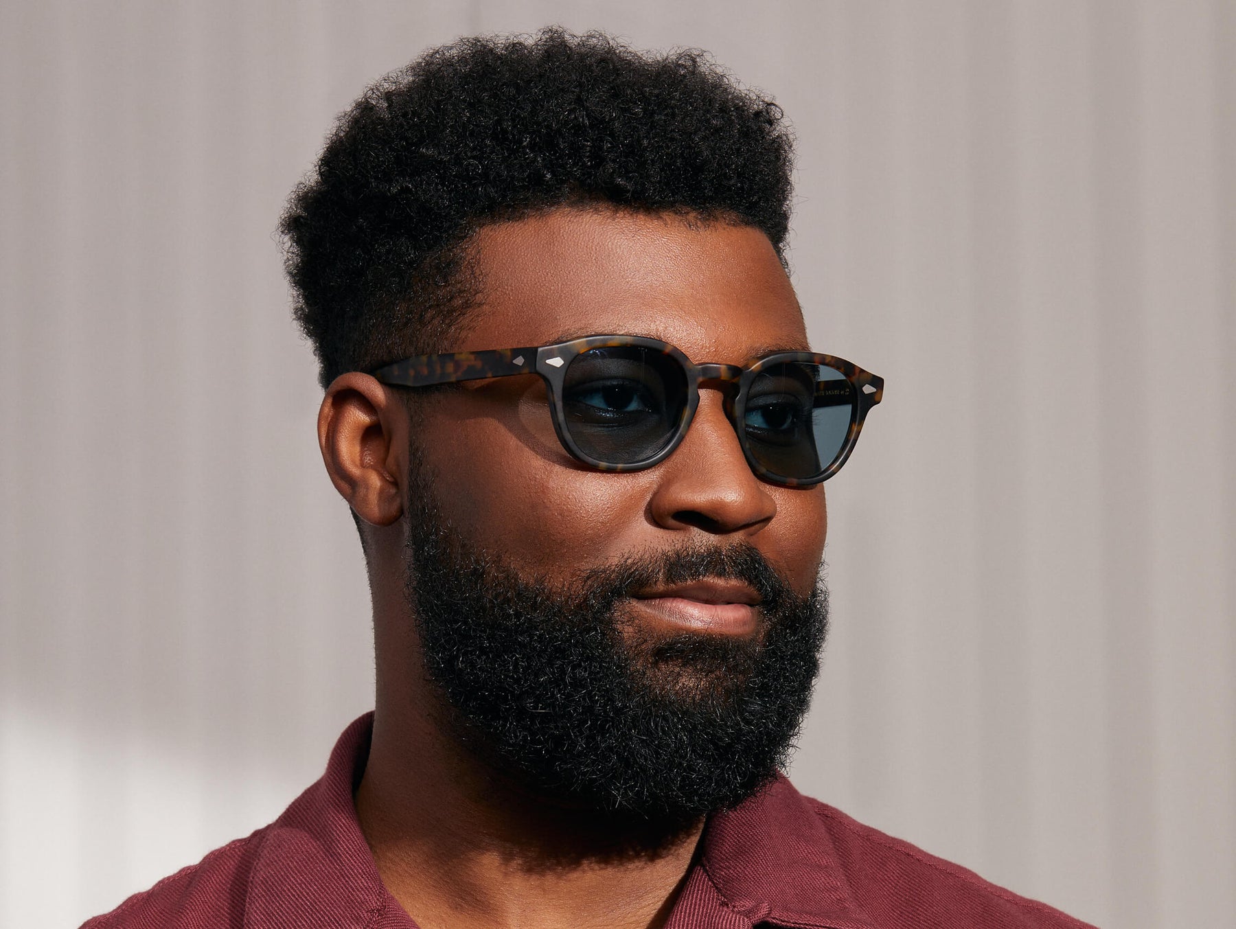 Model is wearing The LEMTOSH SUN in Matte Tortoise in size 49 with Blue Glass Lenses Model is wearing The LEMTOSH SUN in Matte Tortoise in size 49 with Blue Glass Lenses