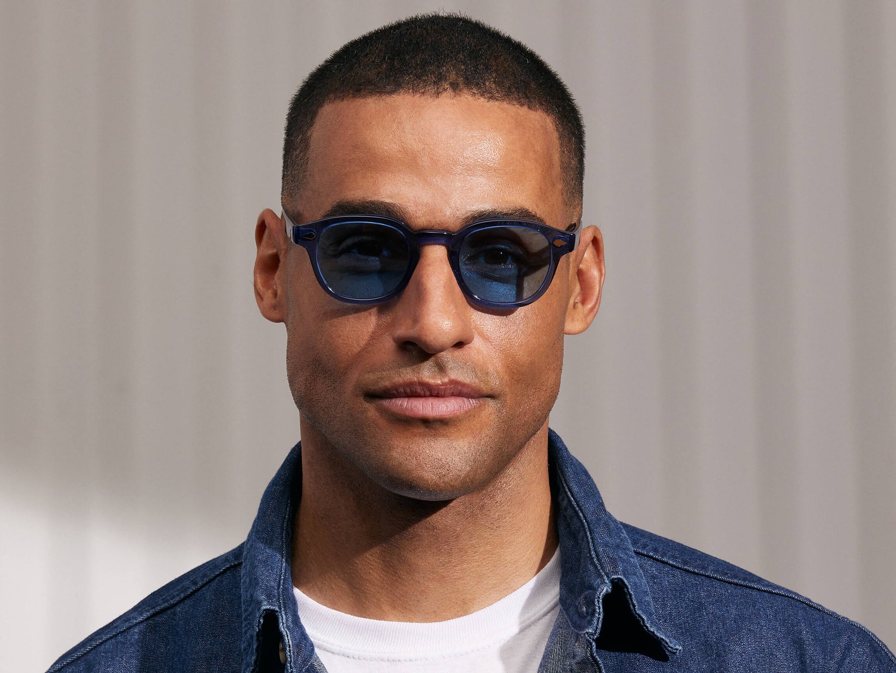 Model is wearing The LEMTOSH in Sapphire in size 46 with Celebrity Blue Tinted Lenses Model is wearing The LEMTOSH in Sapphire in size 46 with Celebrity Blue Tinted Lenses