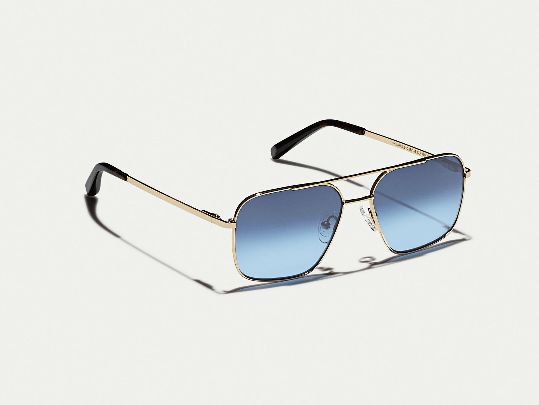 The SHTARKER in Gold with Denim Blue Tinted Lenses The SHTARKER in Gold with Denim Blue Tinted Lenses