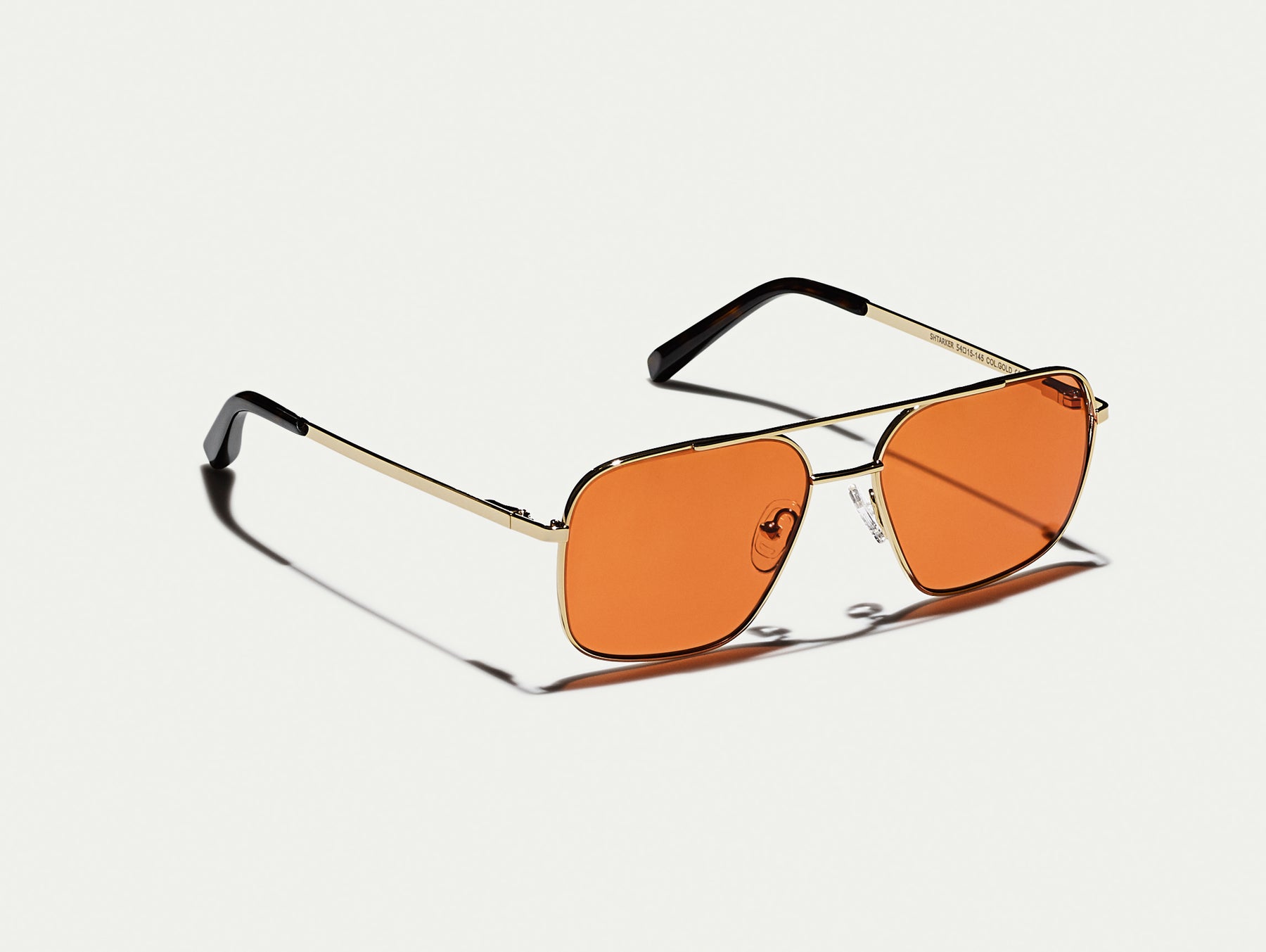 The SHTARKER in Gold with Woodstock Orange Tinted Lenses The SHTARKER in Gold with Woodstock Orange Tinted Lenses