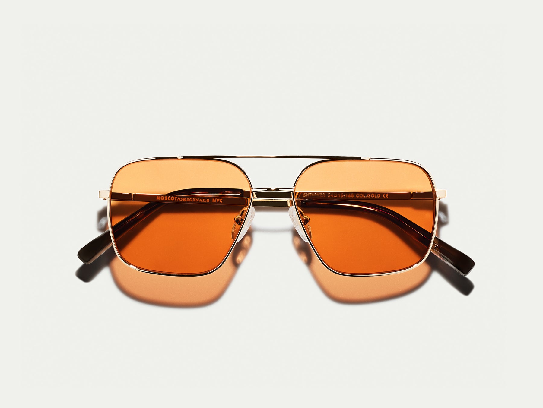 The SHTARKER in Gold with Woodstock Orange Tinted Lenses The SHTARKER in Gold with Woodstock Orange Tinted Lenses