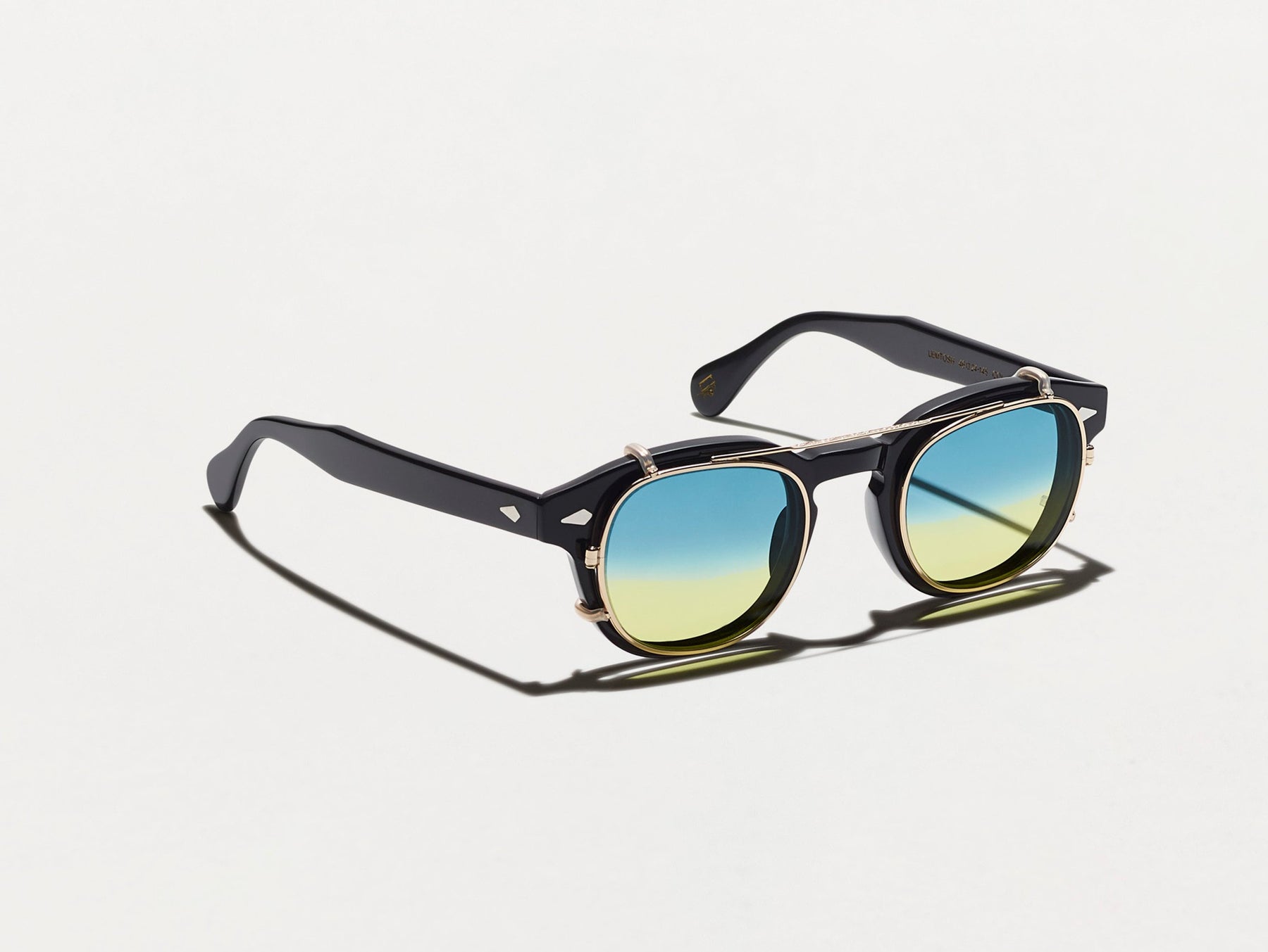 The CLIPTOSH in Gold with Aqua Sunrise Tinted Lenses The CLIPTOSH in Gold with Aqua Sunrise Tinted Lenses