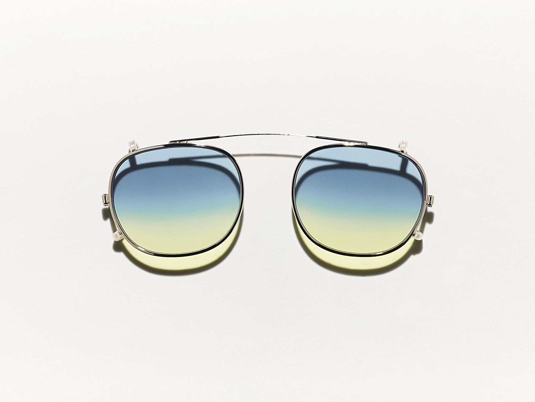 The CLIPTOSH in Gold with Aqua Sunrise Tinted Lenses The CLIPTOSH in Gold with Aqua Sunrise Tinted Lenses