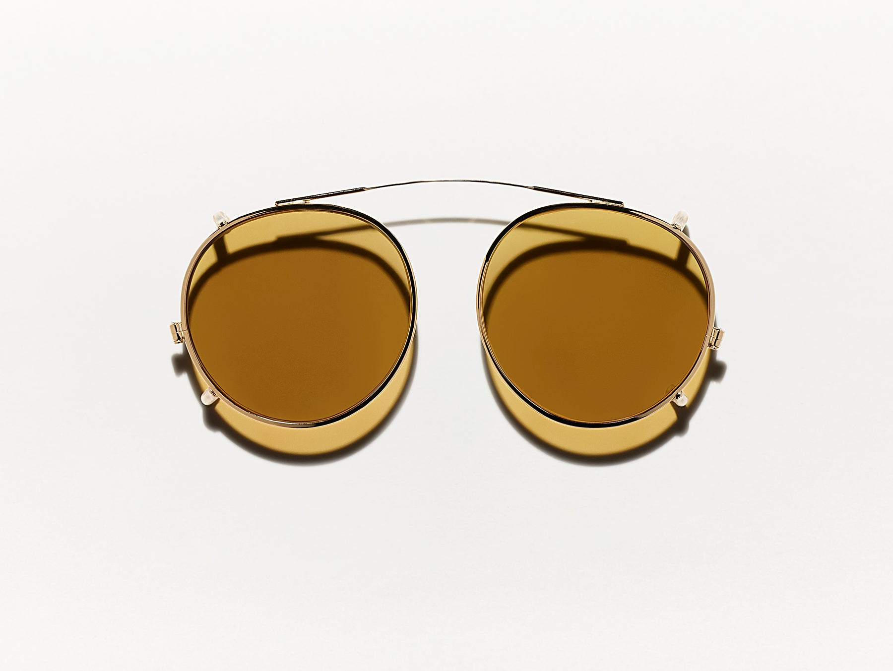 The CLIPZEN in Gold with Amber Tinted Lenses The CLIPZEN in Gold with Amber Tinted Lenses