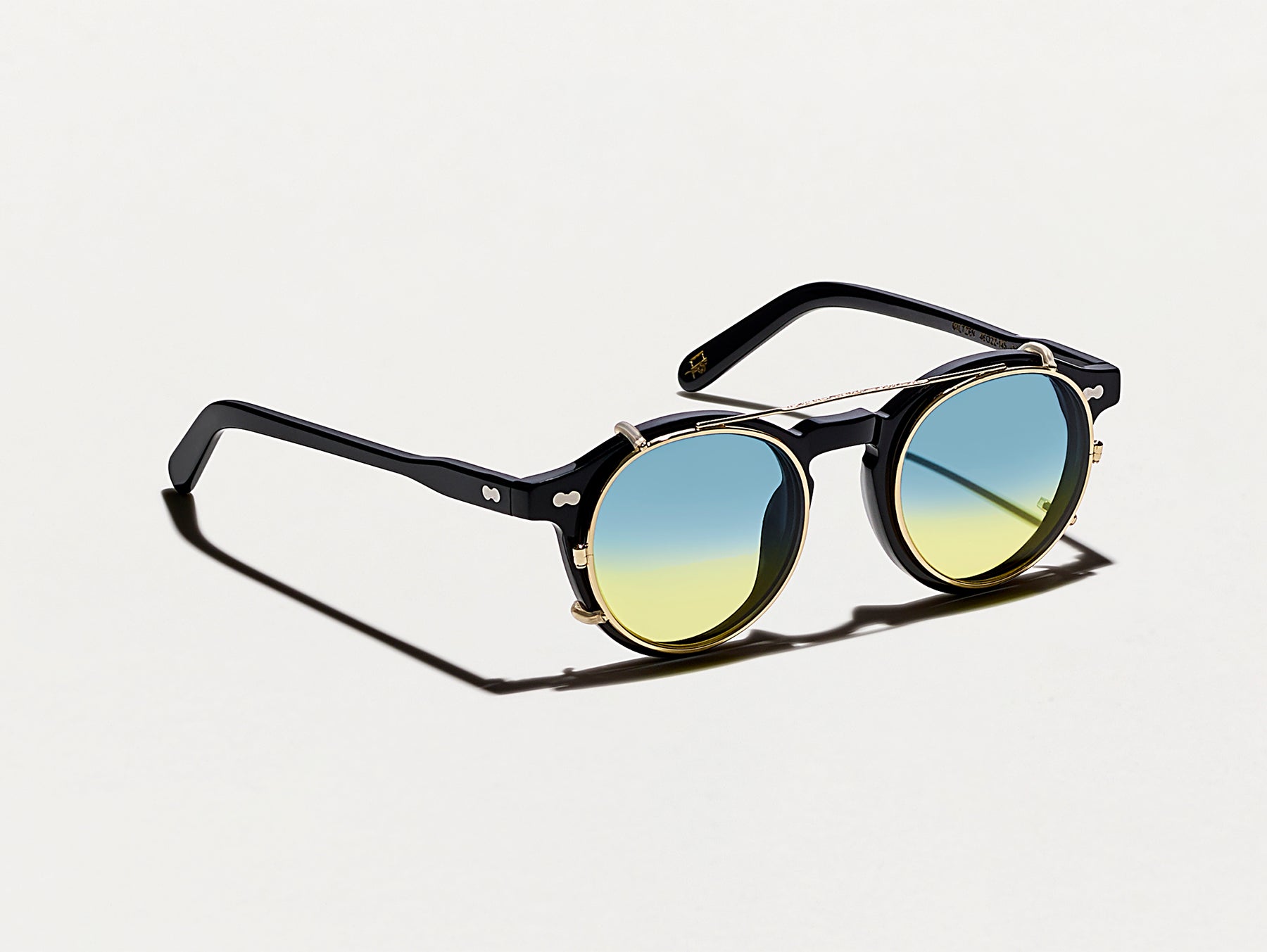 The CLIPZEN in Gold with Aqua Sunrise Tinted Lenses The CLIPZEN in Gold with Aqua Sunrise Tinted Lenses