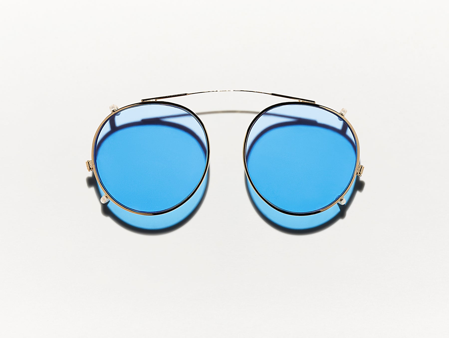 The CLIPZEN in Gold with Celebrity Blue Tinted Lenses The CLIPZEN in Gold with Celebrity Blue Tinted Lenses