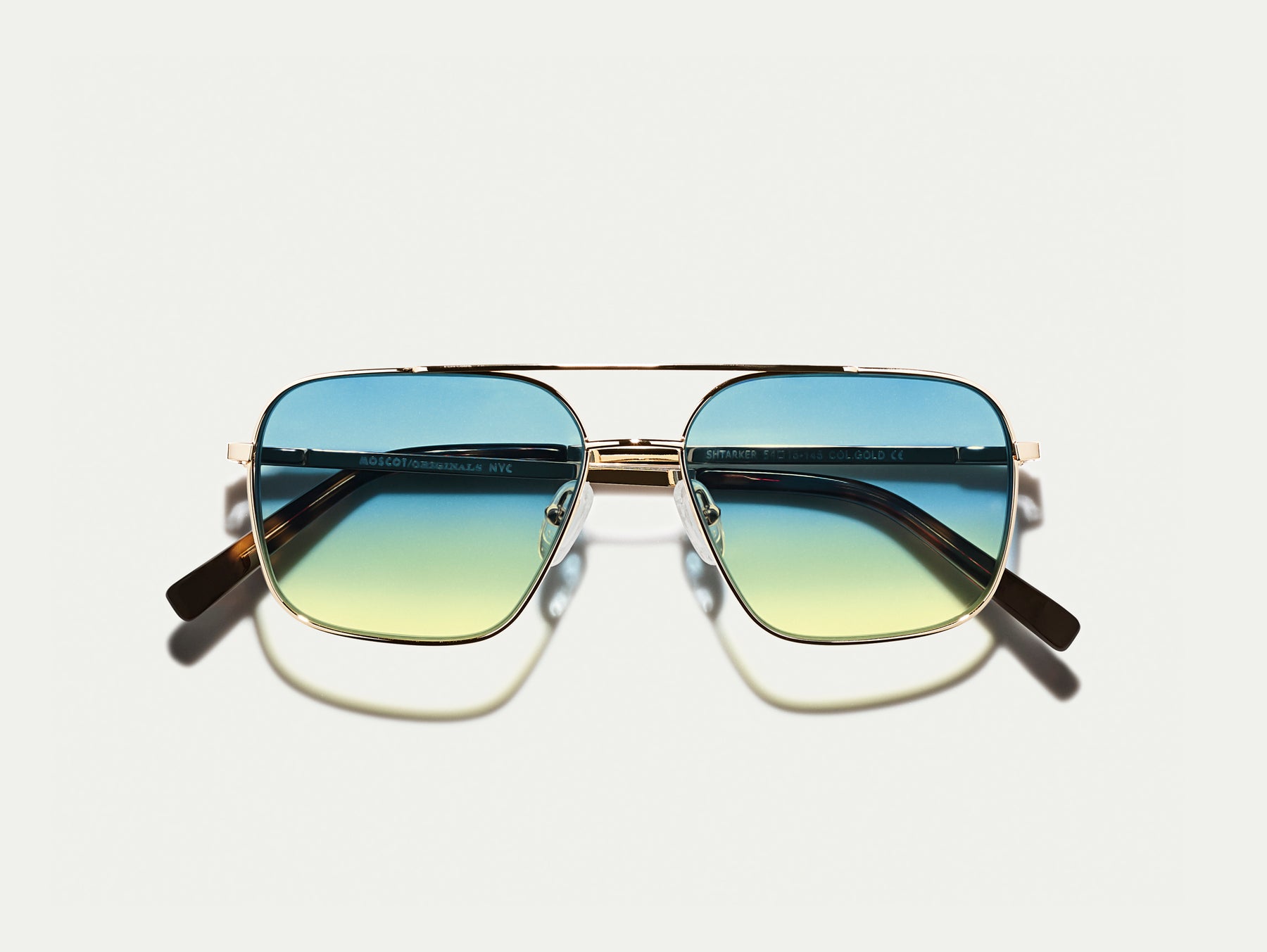 The SHTARKER in Gold with Aqua Sunrise Tinted Lenses The SHTARKER in Gold with Aqua Sunrise Tinted Lenses