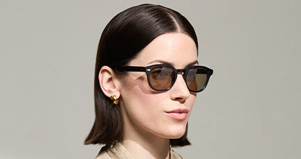 Model is wearing The LEMTOSH-TT 110 with Brown+ glass transition lenses