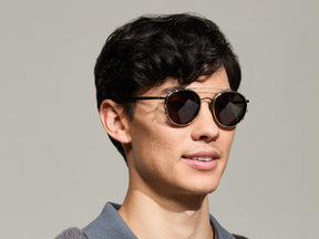 Model is wearing The ZEV CLIP in Gold in size 49 with  G-15 Tinted Lenses