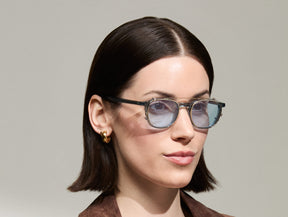 Model is wearing The ARTHUR CLIP in Gold in size 48 with Bel Air Blue Tinted Lenses