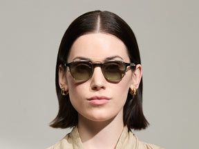 Model is wearing The ARTHUR CLIP in Gold in size 48 with Forest Wood Tinted Lenses