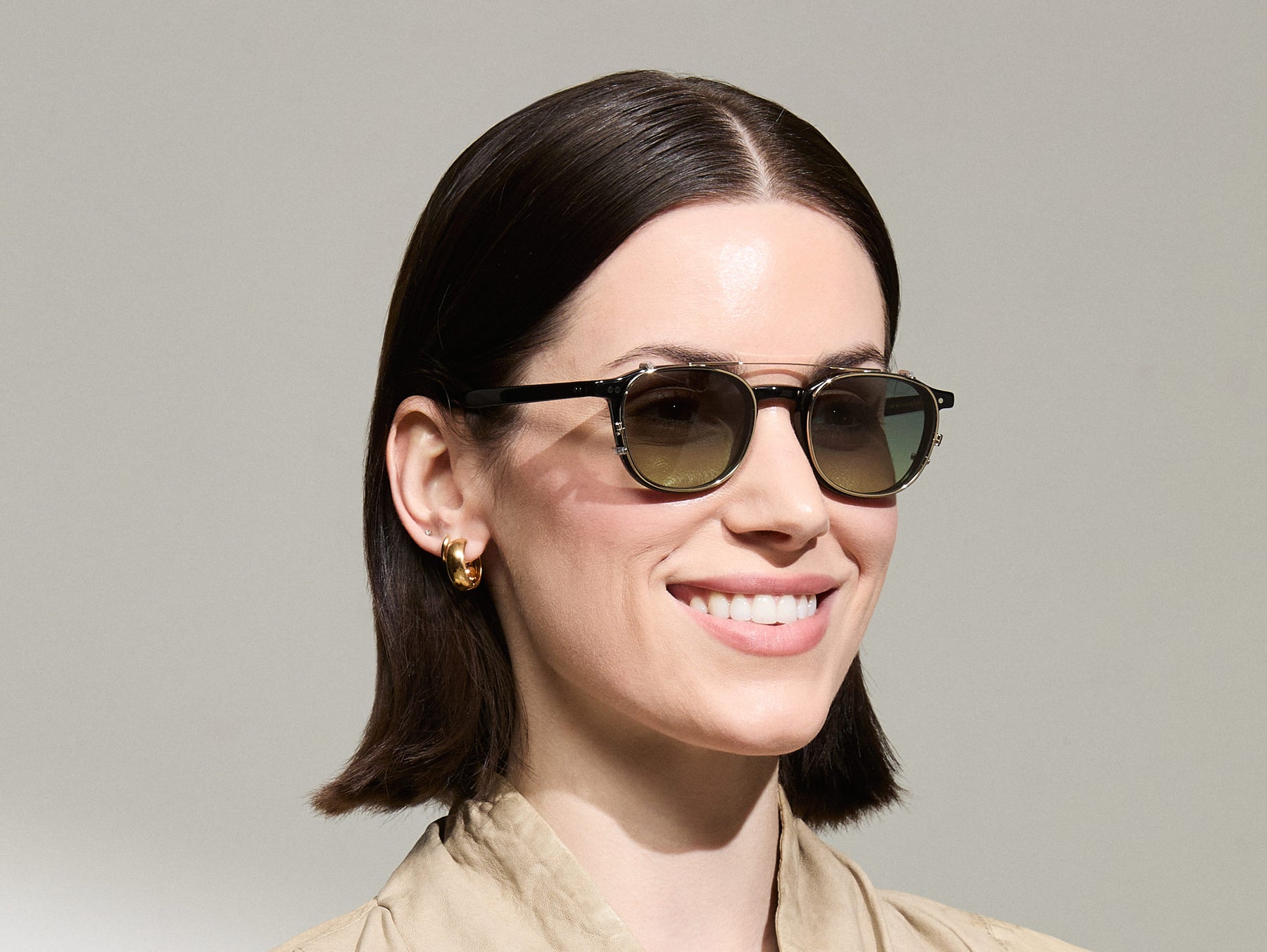 Model is wearing The ARTHUR CLIP in Gold in size 48 with Forest Wood Tinted Lenses