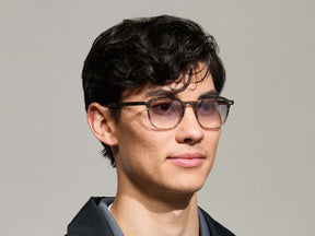 Model is wearing The ARTHUR SUN in Charcoal in size 51 with American Grey Fade Tinted Lenses