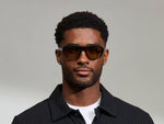 Model is wearing The AVRAM in size 54 in Black with Amber Tinted Lenses