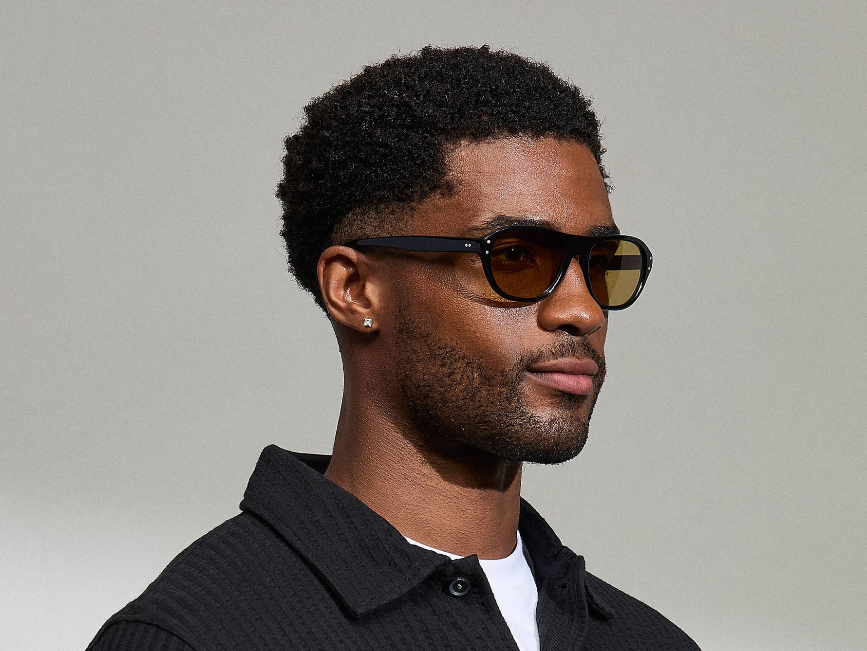 Model is wearing The AVRAM in size 54 in Black with Amber Tinted Lenses