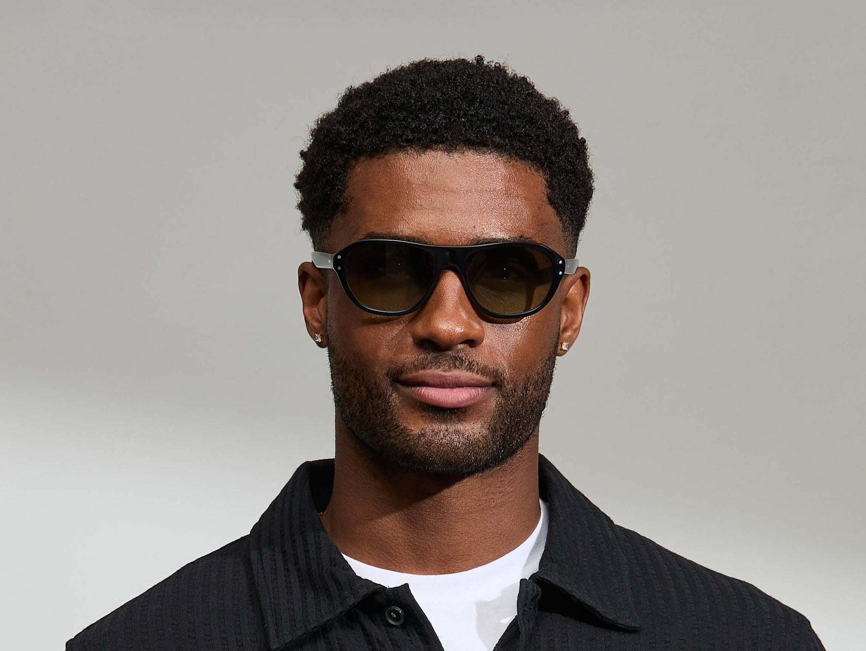 Model is wearing The AVRAM in size 54 in Black with Forest Wood Tinted Lenses