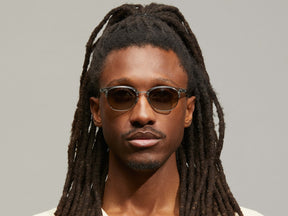 Model is wearing The AYGEN SUN in size 51 in Sage with Forest Wood Tinted Lenses