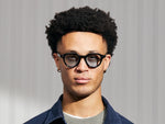 Model is wearing The BAITSIM SUN in Black in size 48 with Bel Air Blue Tinted Lenses