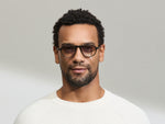 Model is wearing The BISHEART SUN in size 52 in Black with American Grey Fade Tinted Lenses