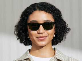 Model is wearing The BOYCHIK SUN in Dark Green in size 52 with Calibar Green Glass Lenses