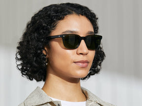 Model is wearing The BOYCHIK SUN in Dark Green in size 52 with Calibar Green Glass Lenses