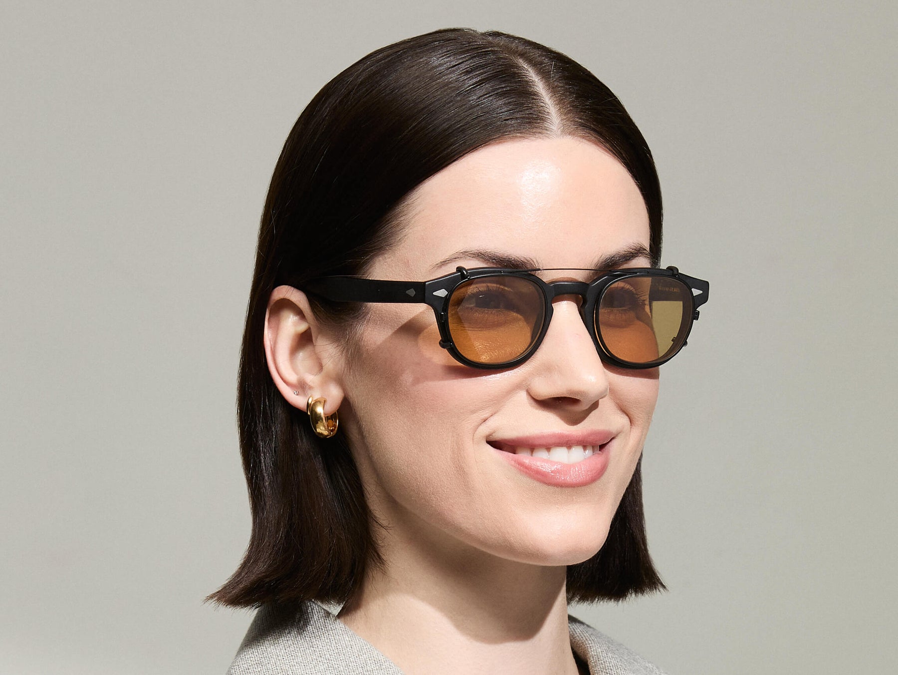 The Model is wearing The CLIPTOSH in Matte Black in size 46 with Amber Tinted Lenses