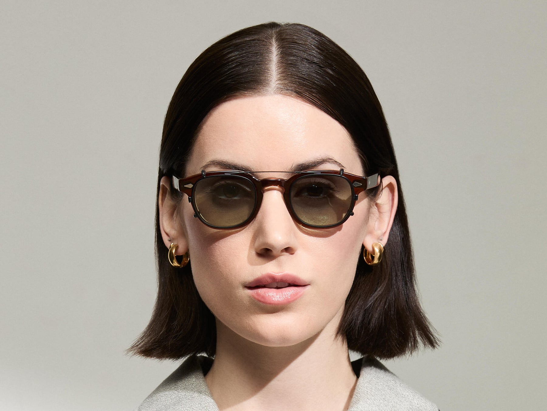 The Model is wearing The CLIPTOSH in Matte Black in size 46 with Forest Wood Tinted Lenses