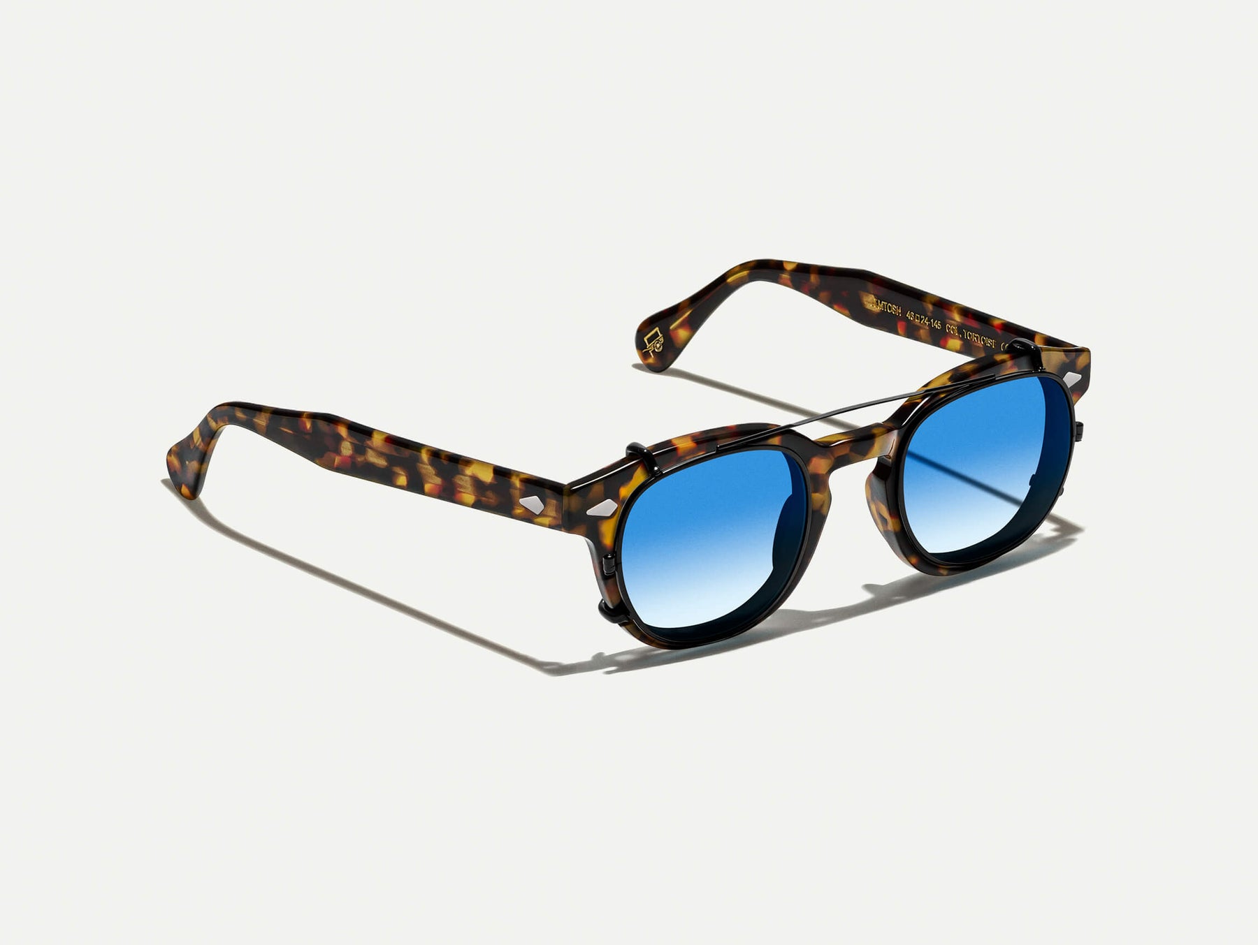 The CLIPTOSH in Matte Black with Broadway Blue Fade Tinted Lenses