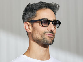 Model is wearing The CLIPTOSH in Gold in size 46 with American Grey Fade Tinted Lenses