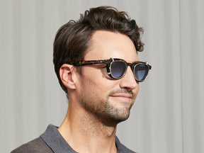 Model is wearing The DAHVEN CLIP in Gold in size 47 with Denim Blue Tinted Lenses