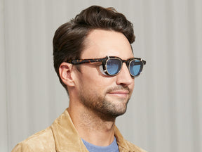 Model is wearing The DAHVEN CLIP in Gold in size 47 with Celebrity Blue Tinted Lenses