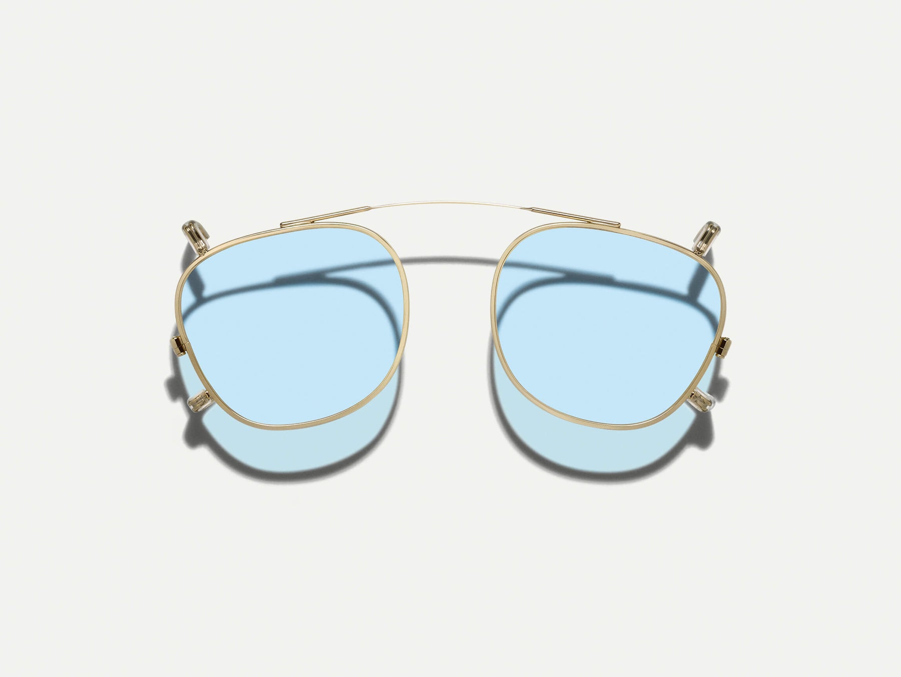 The DAHVEN CLIP in Gold with Bel Air Blue Tinted Lenses